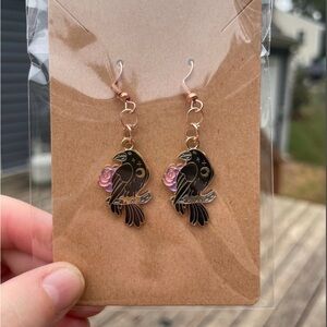 Hand-pieced Black Bird Earrings with a pink and purple flower
